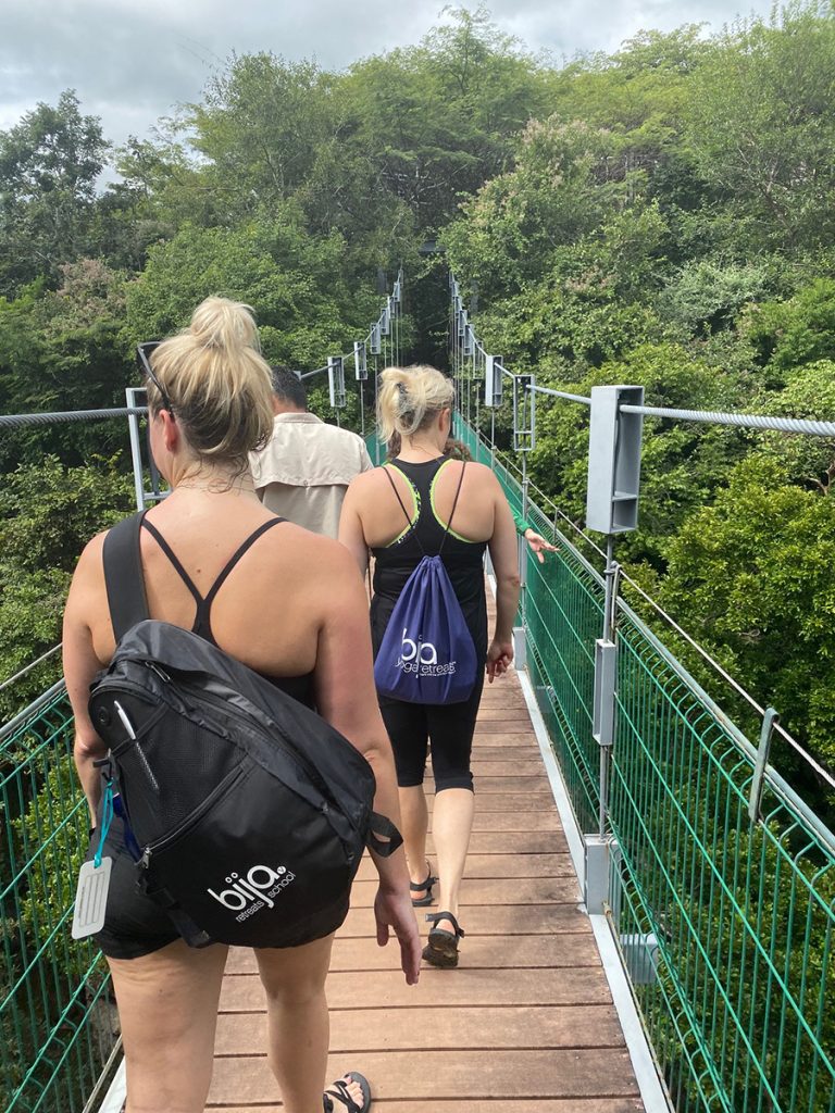 Yoga retreat adventure crossing suspension bridge
