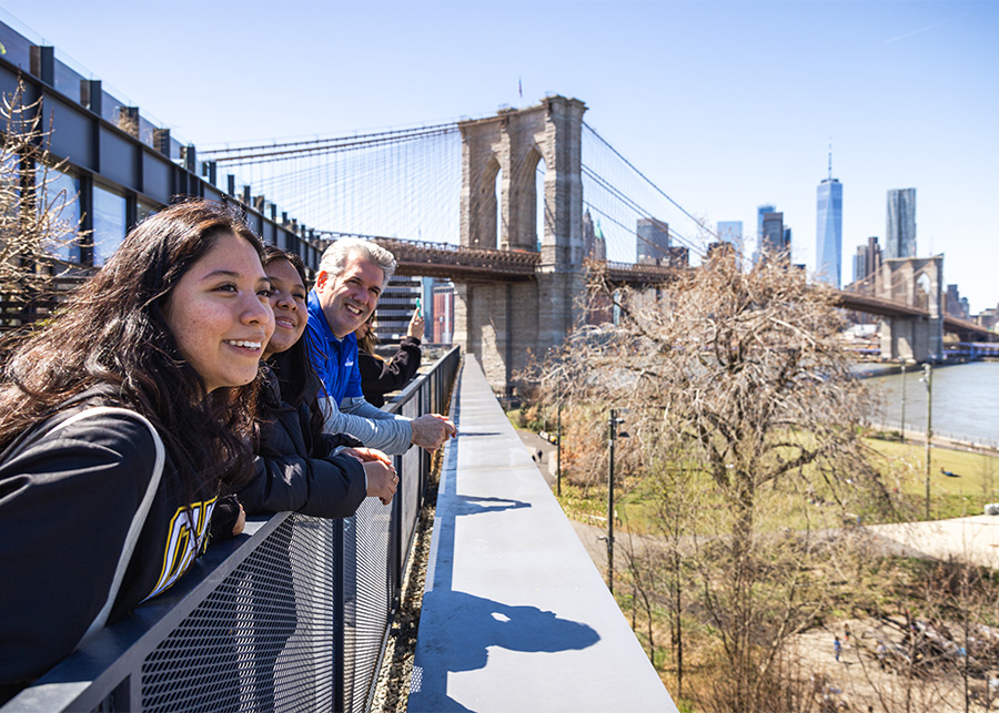 Image of people with the Brooklyn Bridge in the background.